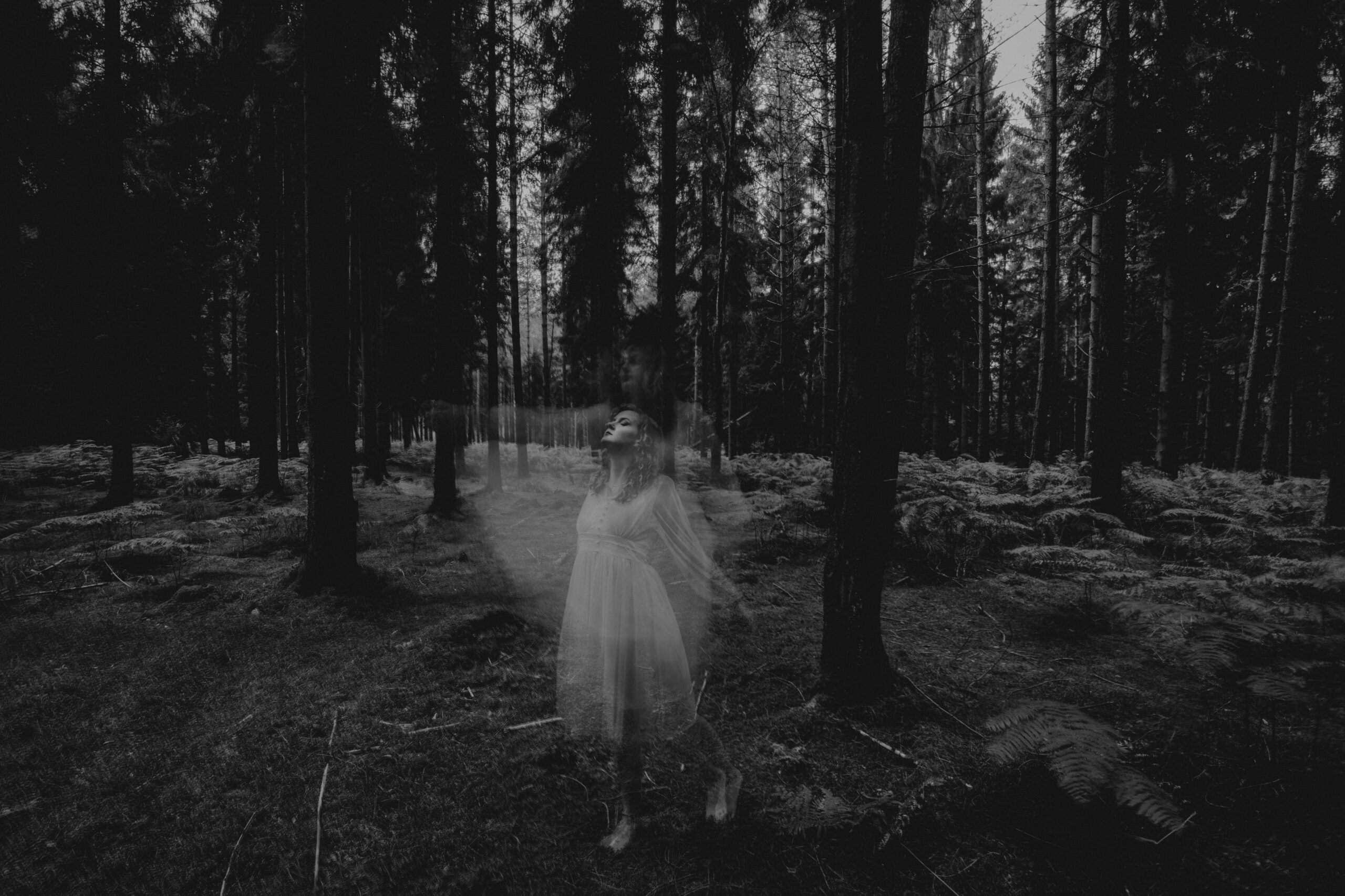 Ghost photography - a ghost leaving a woman's body in black and white